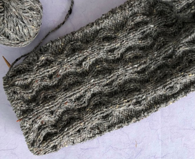 knit sleeve with cables still on knitting needles