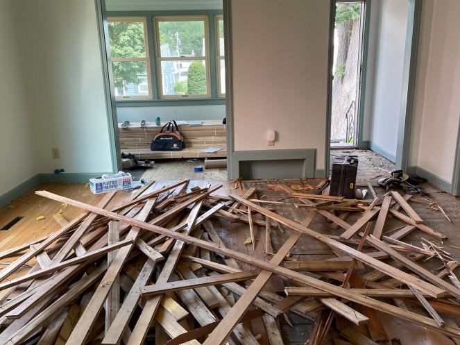 criss-crossed pile of wood boards scattered on floor