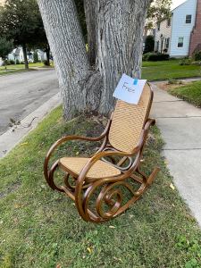 bentwood rocking chair sitting on green grass boulevard