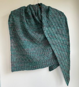 handknit green shawl with interconnecting cables twisted throughout
