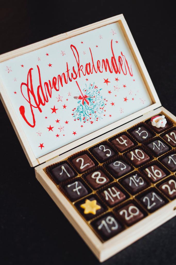 a box of chocolates with white numbers for each day of December