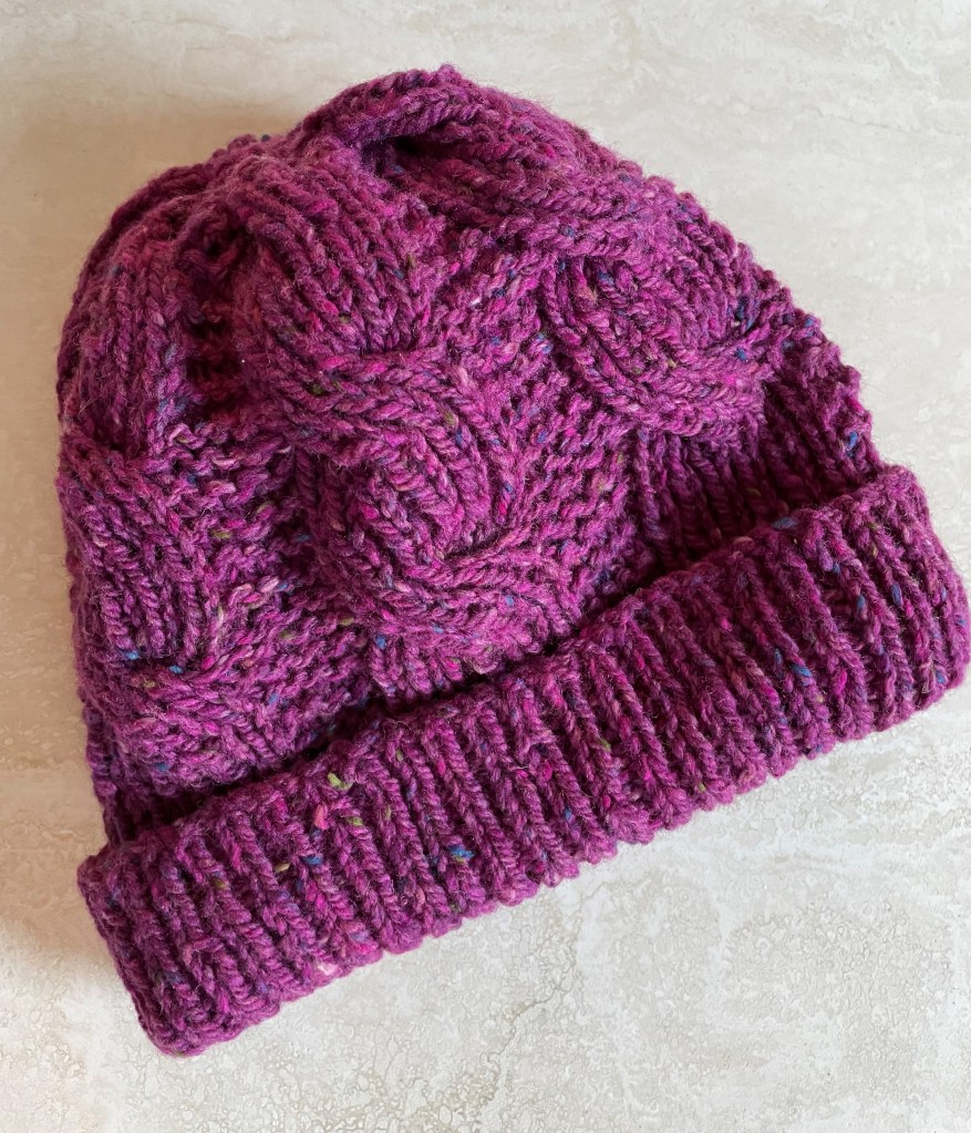 hand knit cable beanie in magenta tweed yarn