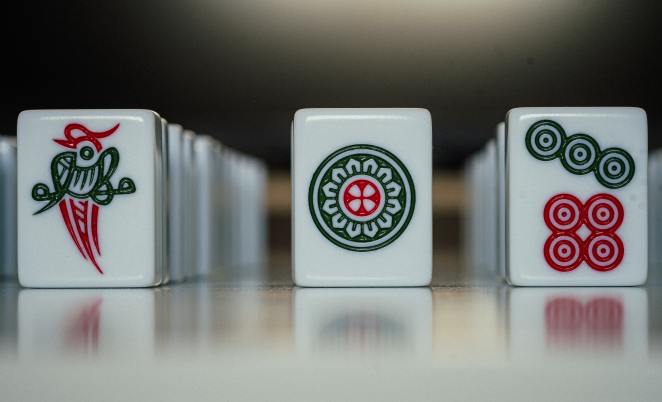 three rows of mahjong tiles with white backgrounds and red and green imagery