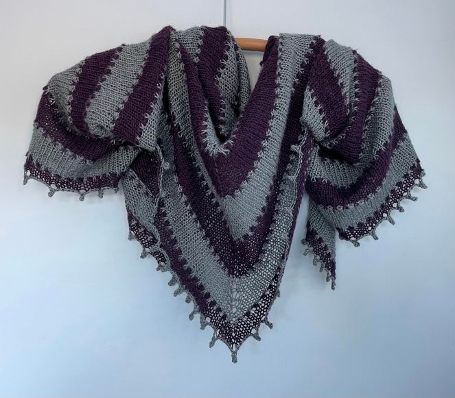 handknit gray and purple striped triangular shawl with lacy edge