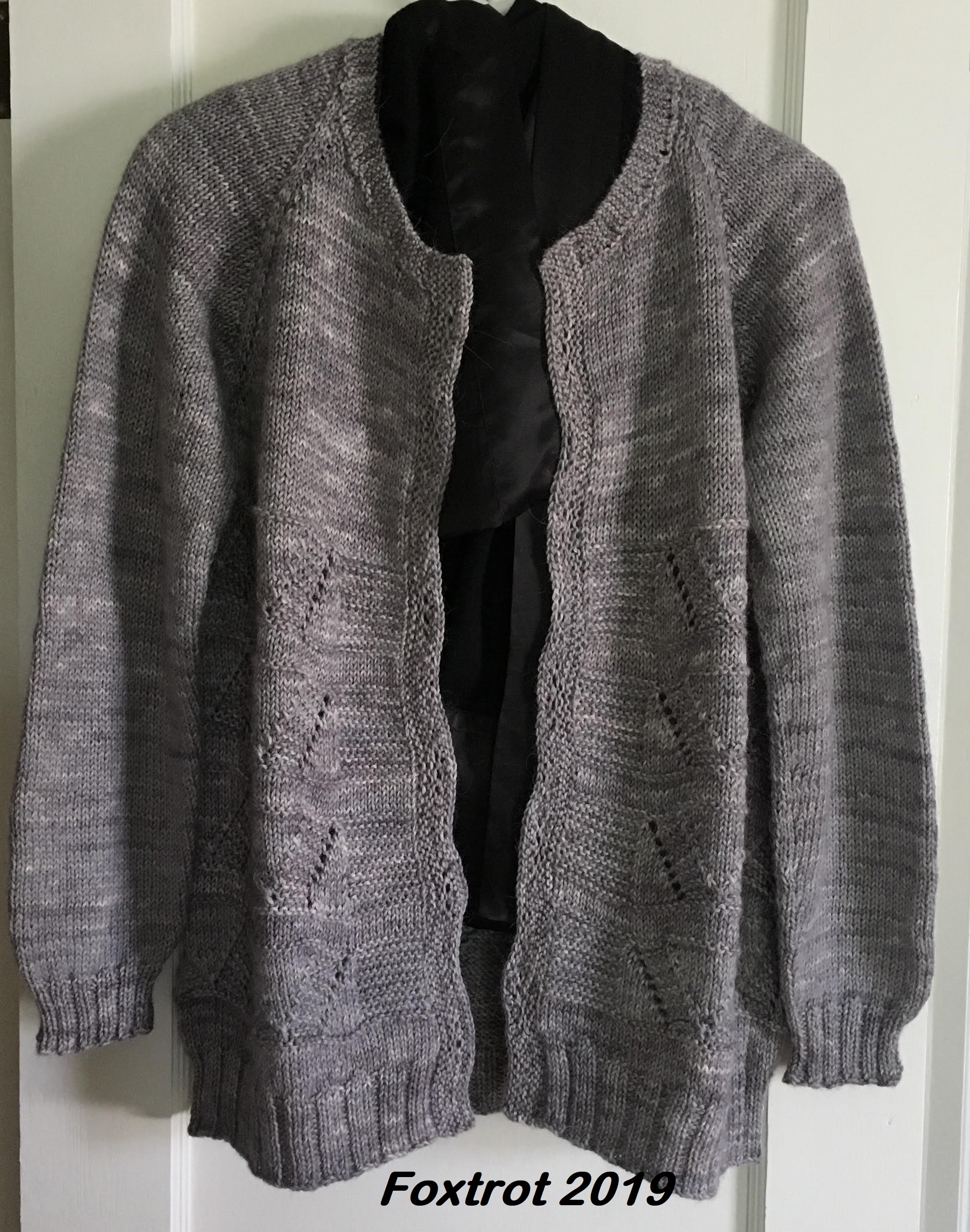 handknit gray sweater hanging on white background with note that reads Foxtrot 2019