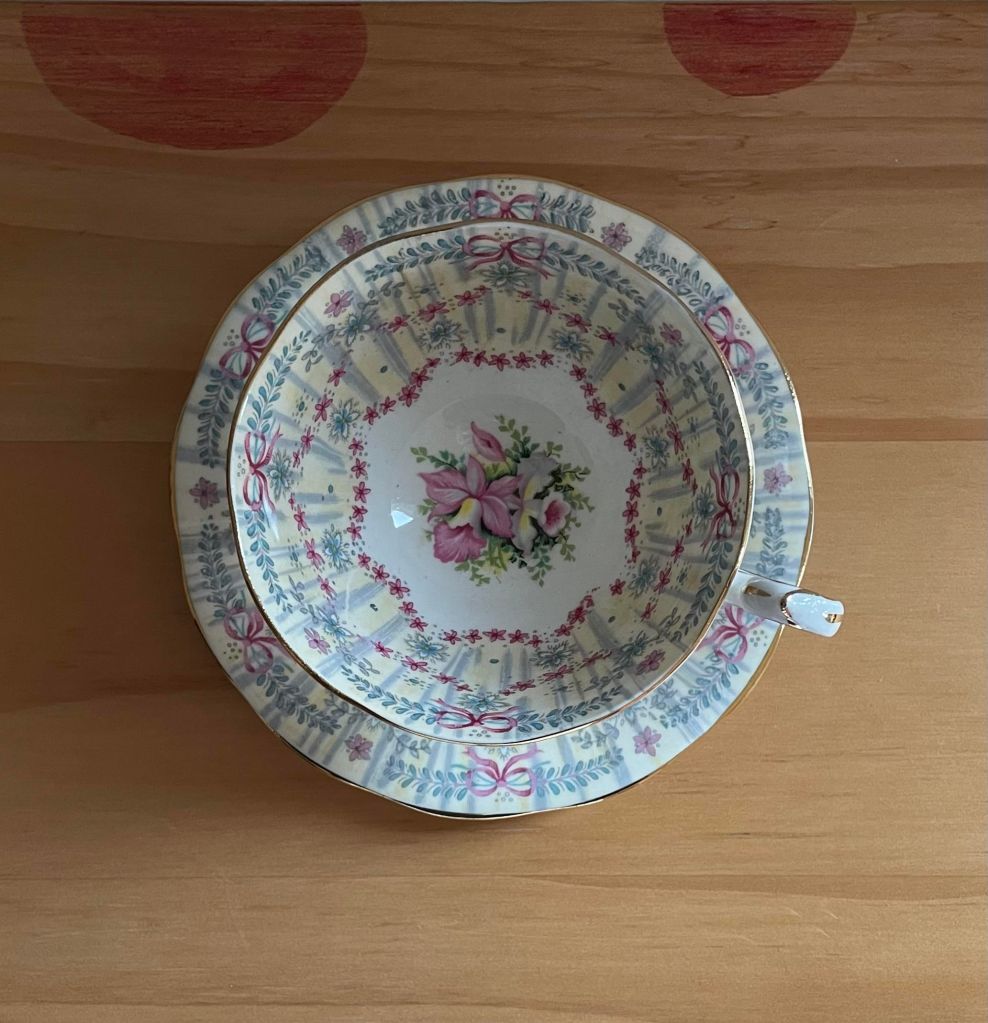 pick and blue china cup and saucer on a wooden background