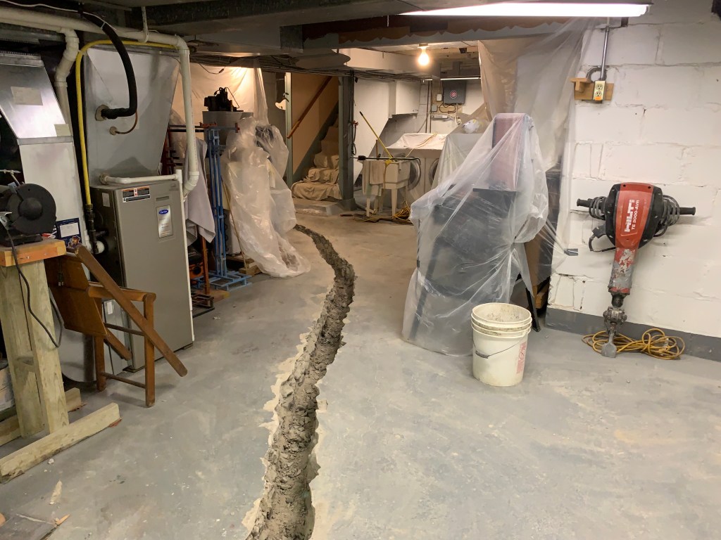 basement construction with open trough criss crossing floor