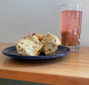 muffins on a blue plate and a glass of pink lemonade
