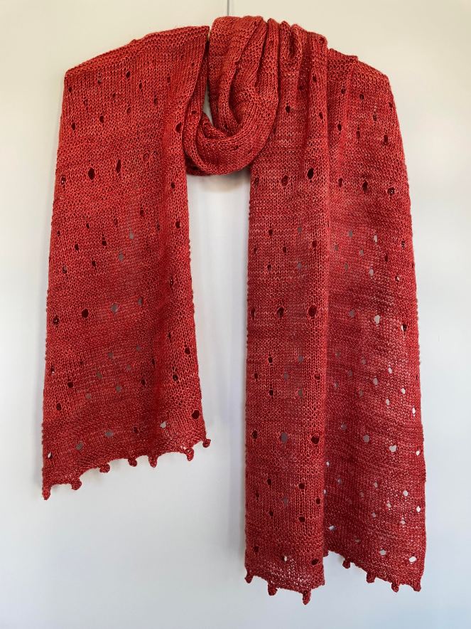 handknit reddish brown shawl with lacy eyelets and bobbles
