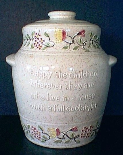 white pottery covered cookie jar with colored decoration at top and bottom edge