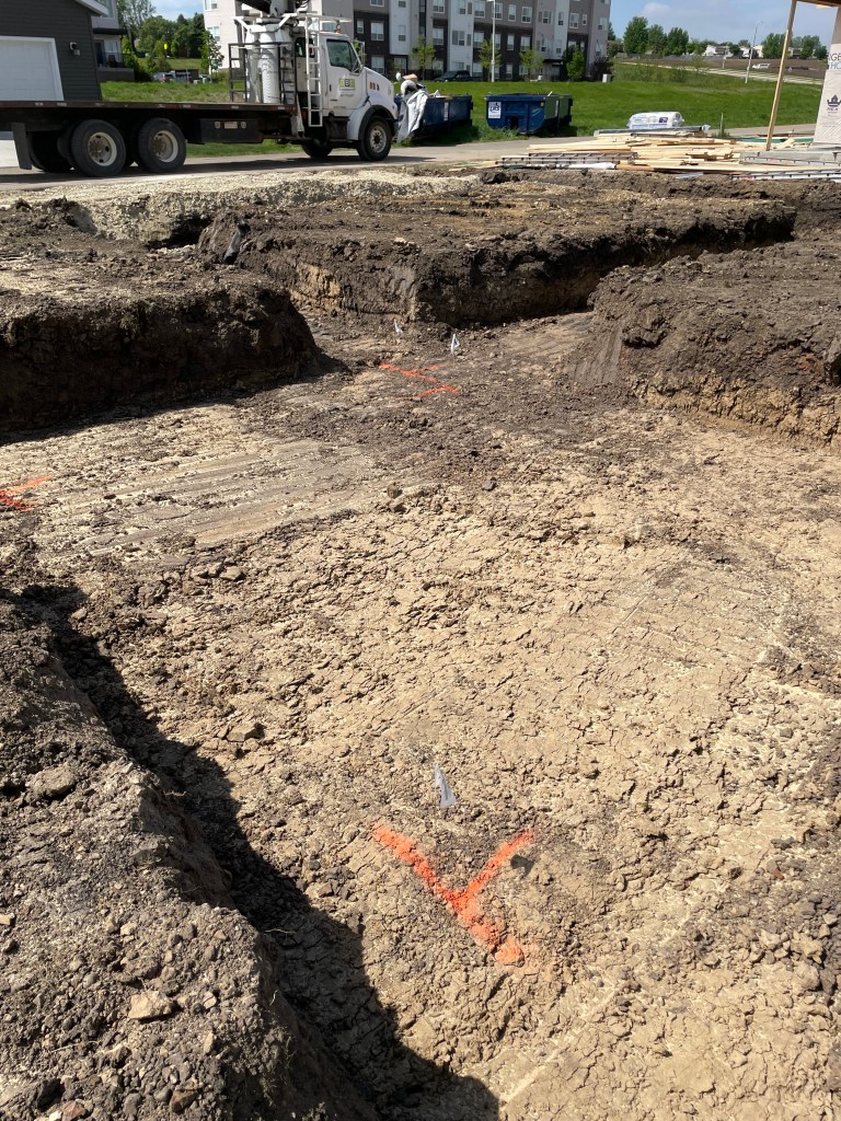 bare dirt trough with orange spray paint