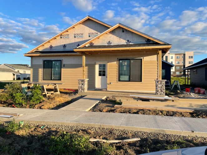 new house under construction with siding one-half up the front wall