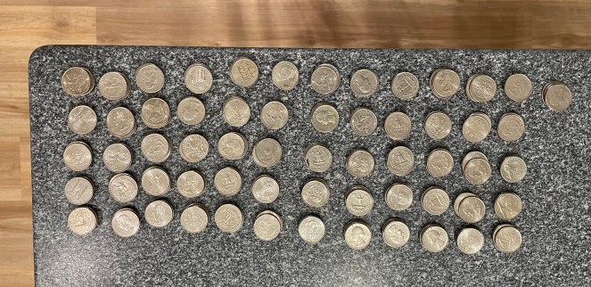 stacks of quarters on a black granite countertop