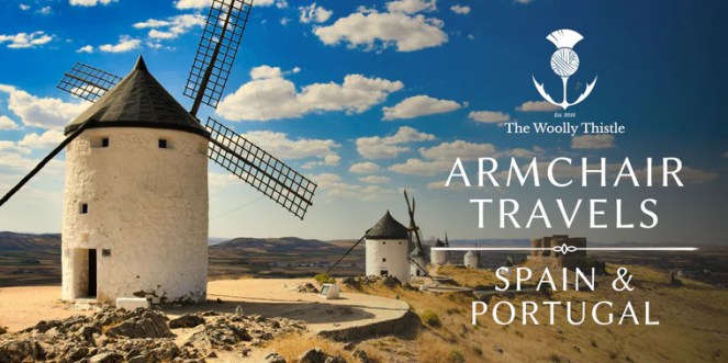 Spanish windmills along a hilltop with vibrant blue sky