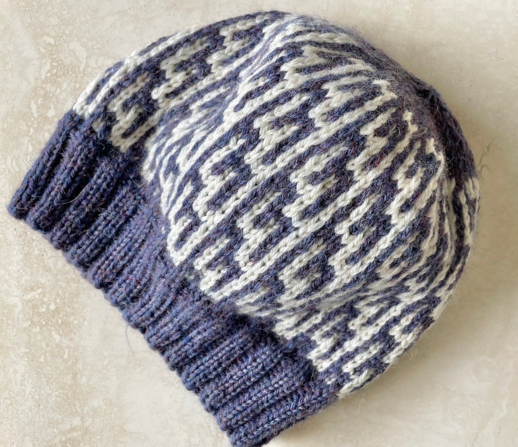 blue and cream colored beanie with a geometric design
