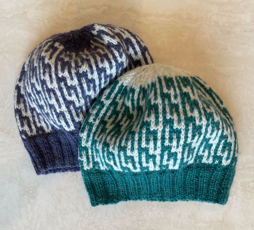 two beanie with geometric patterns - left blue and cream colored right green and cream colored